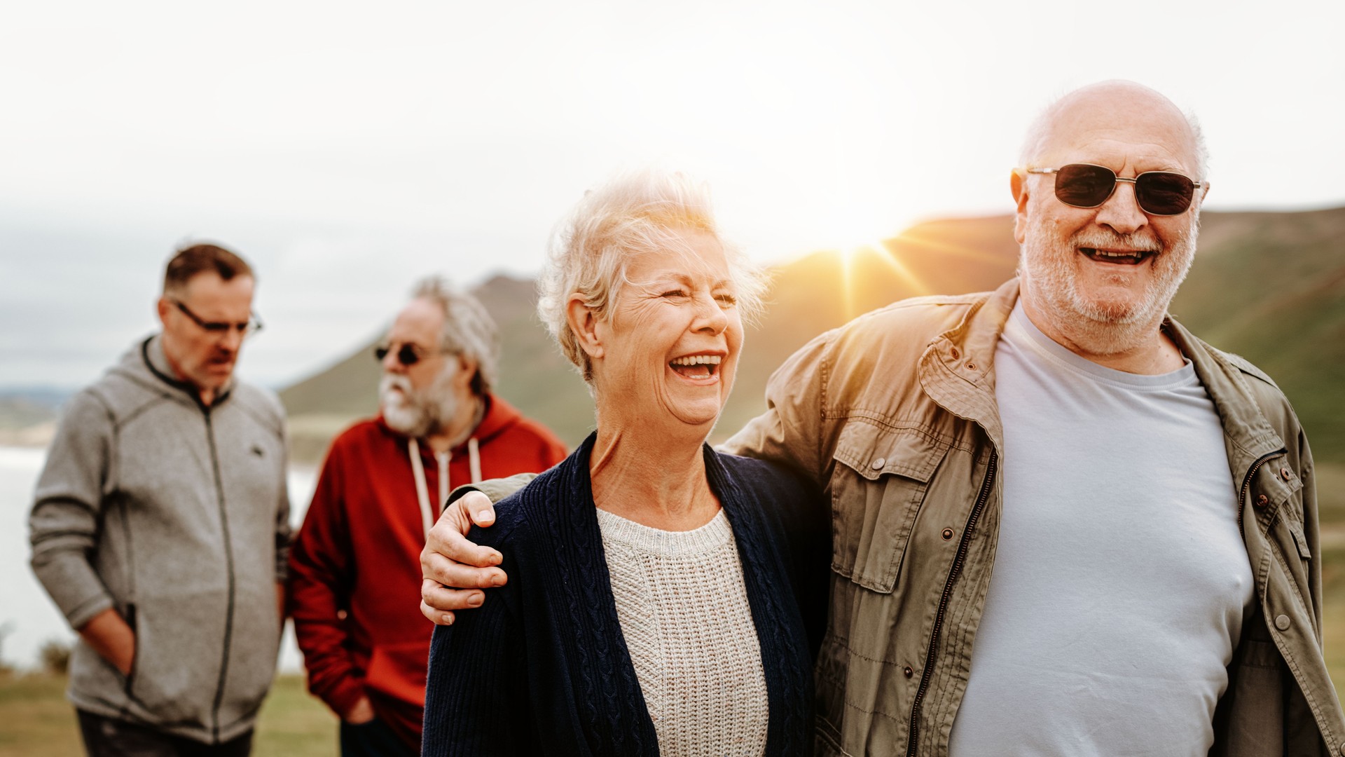 Elderly Caucasian couple and friends smiling outdoors, Group of elderly friends enjoying a sunny day outdoor nature. Happy elderly couple with friends, Elderly men and woman, outdoors, smiling.