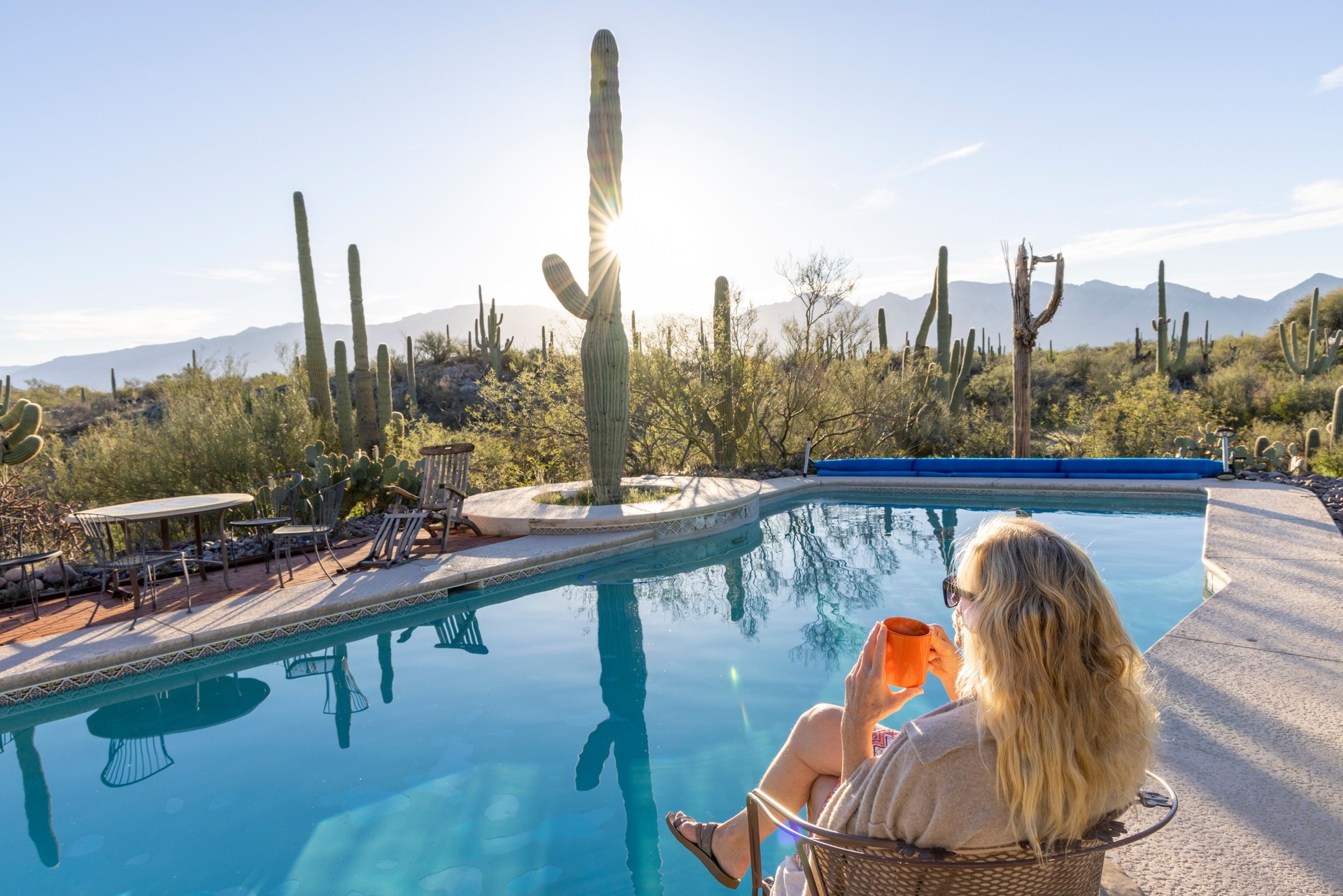 Mature woman relaxes by swimming pool